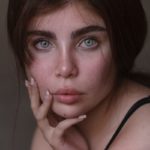 a woman with blue eyes posing for a picture