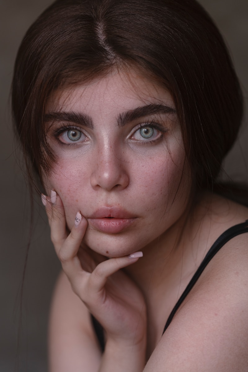 a woman with blue eyes posing for a picture